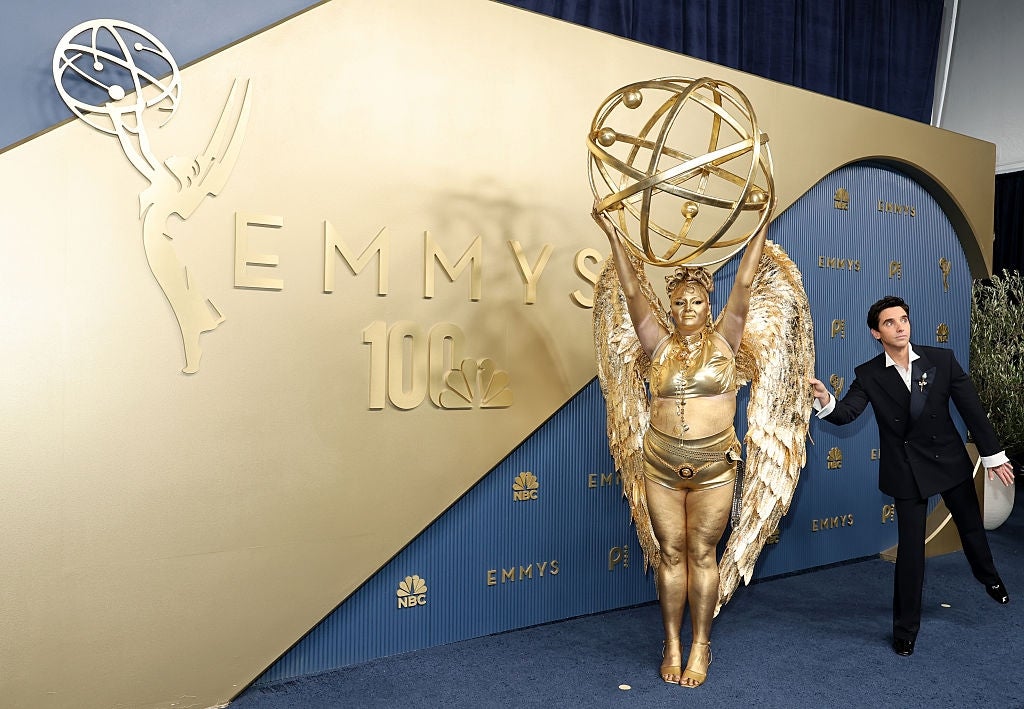 Meg in gold angel costume as Emmy replica