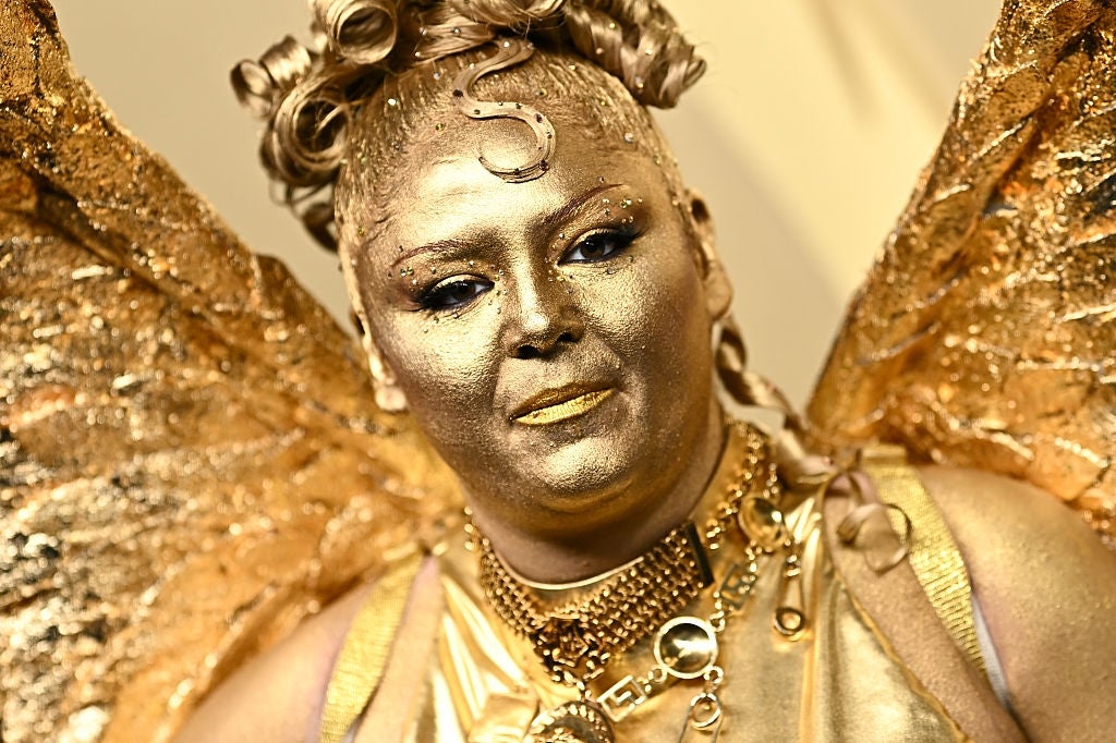 Meg with elaborate golden makeup and ornate accessories, resembling a fantasy character