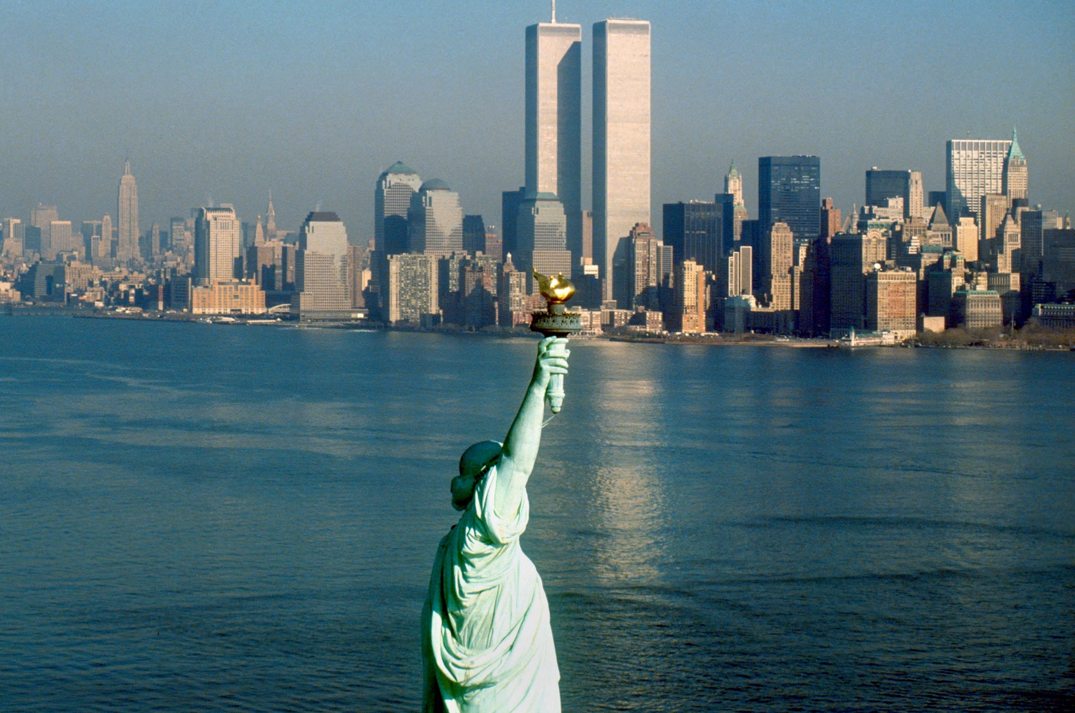 Statue of Liberty with a backdrop of New York City's skyline, featuring the Twin Towers