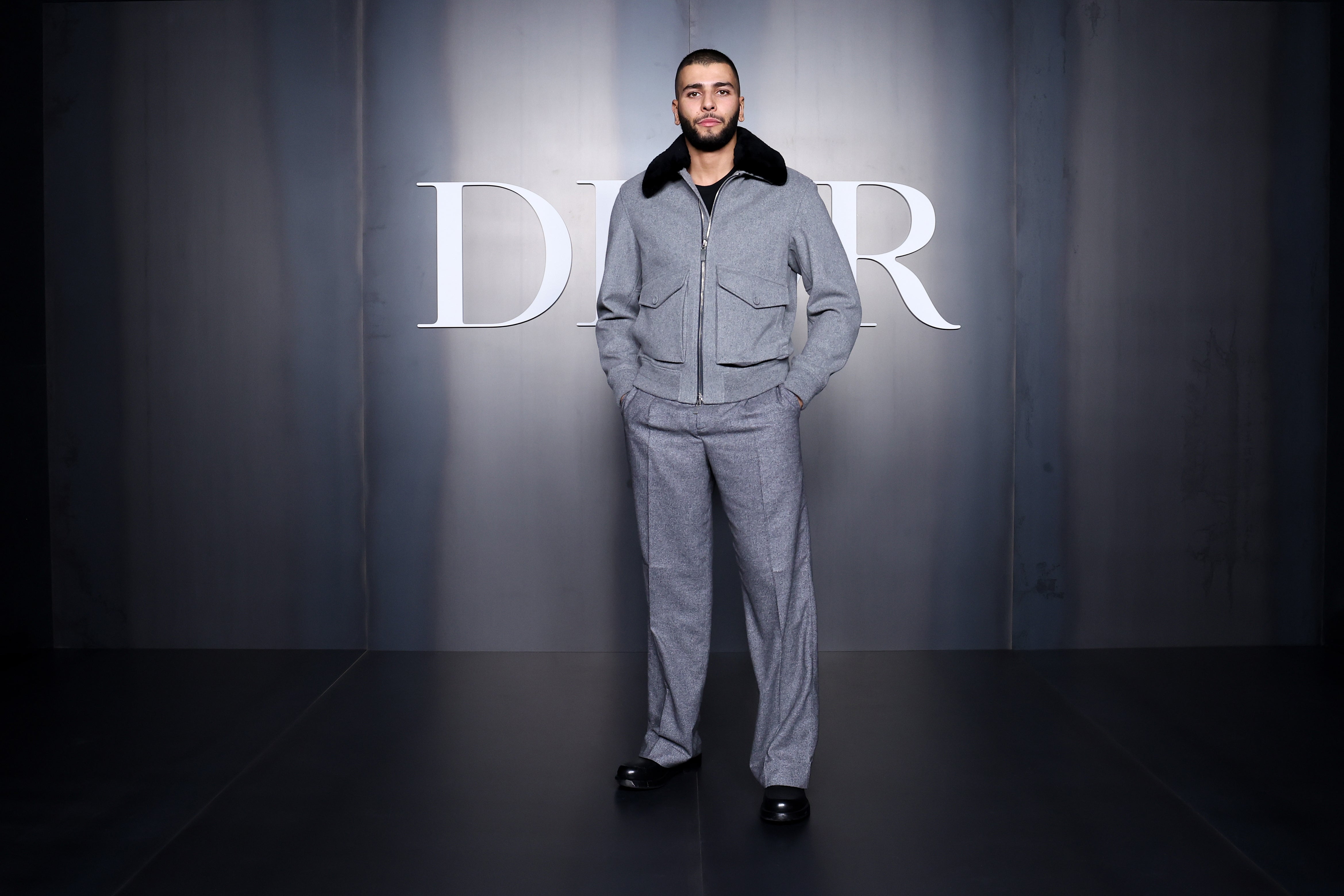 Person i skreddersydd dress poserer på Dior-arrangementet