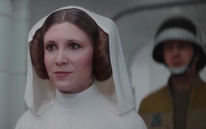 A person dressed as a sci-fi character with a white hooded outfit and iconic coiffed hairstyle, accompanied by a person in a helmet in the background