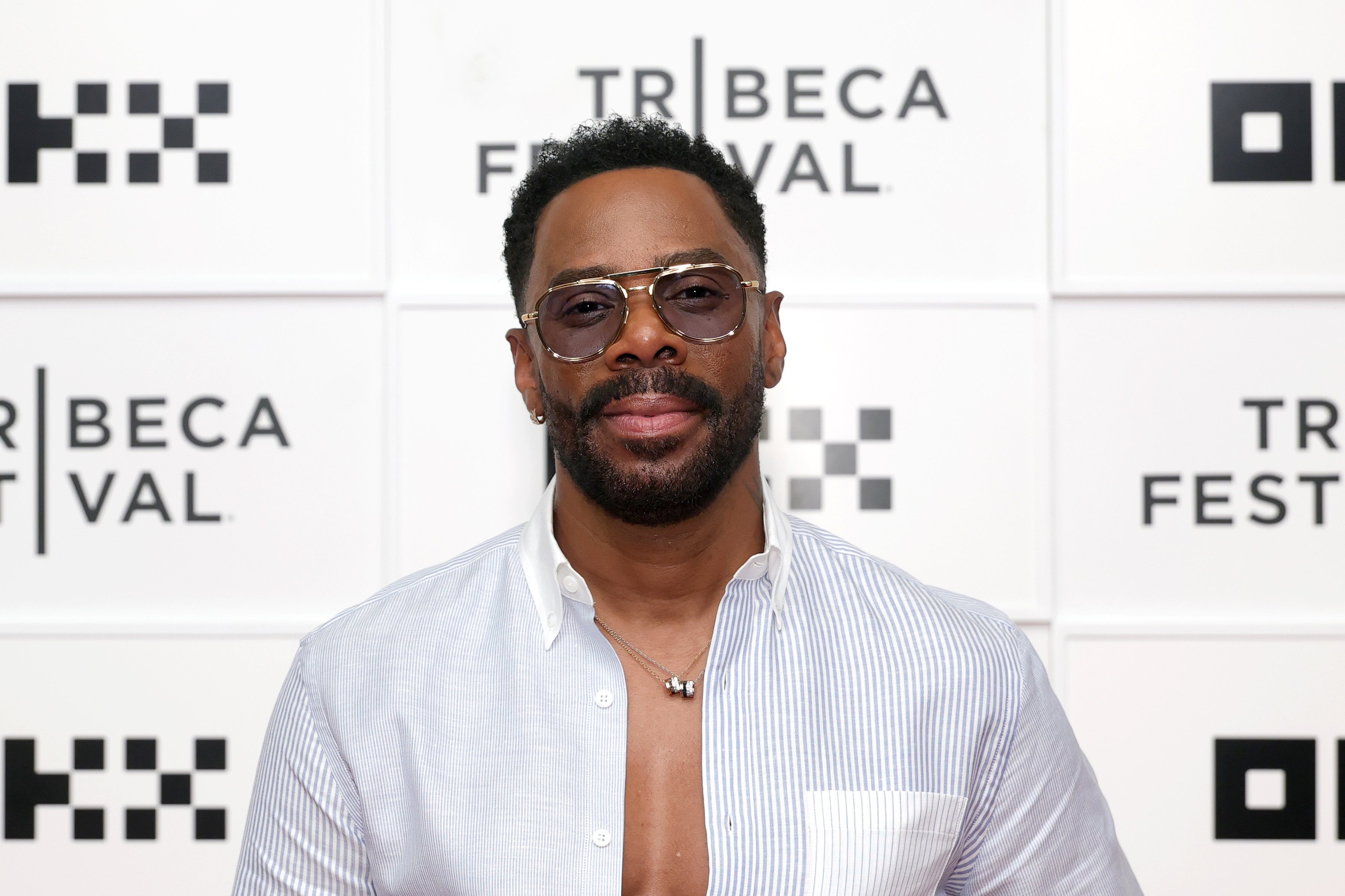 Person in sunglasses and a partially unbuttoned shirt at the Tribeca Festival