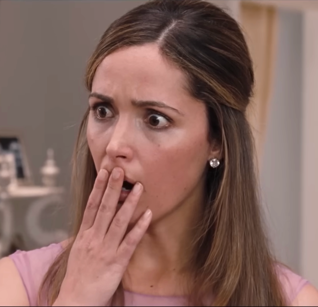 Rose Byrne with surprised expression, hand covering mouth