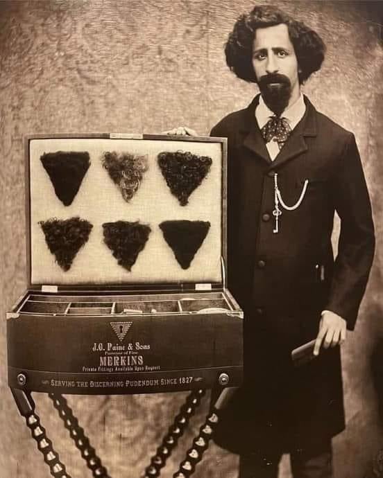 Vintage photo of man in formal attire displaying a selection of merkins from J.O. Paine & Sons, presented in a case on a stand with text about the company