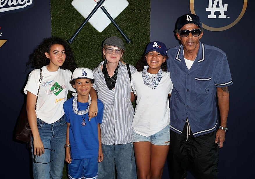 Group of five people at a World Series event; casual attire, including caps and sunglasses