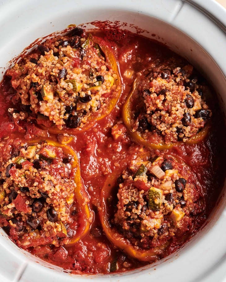 Stuffed peppers with quinoa, black beans, zucchini, and tomato sauce in a slow cooker