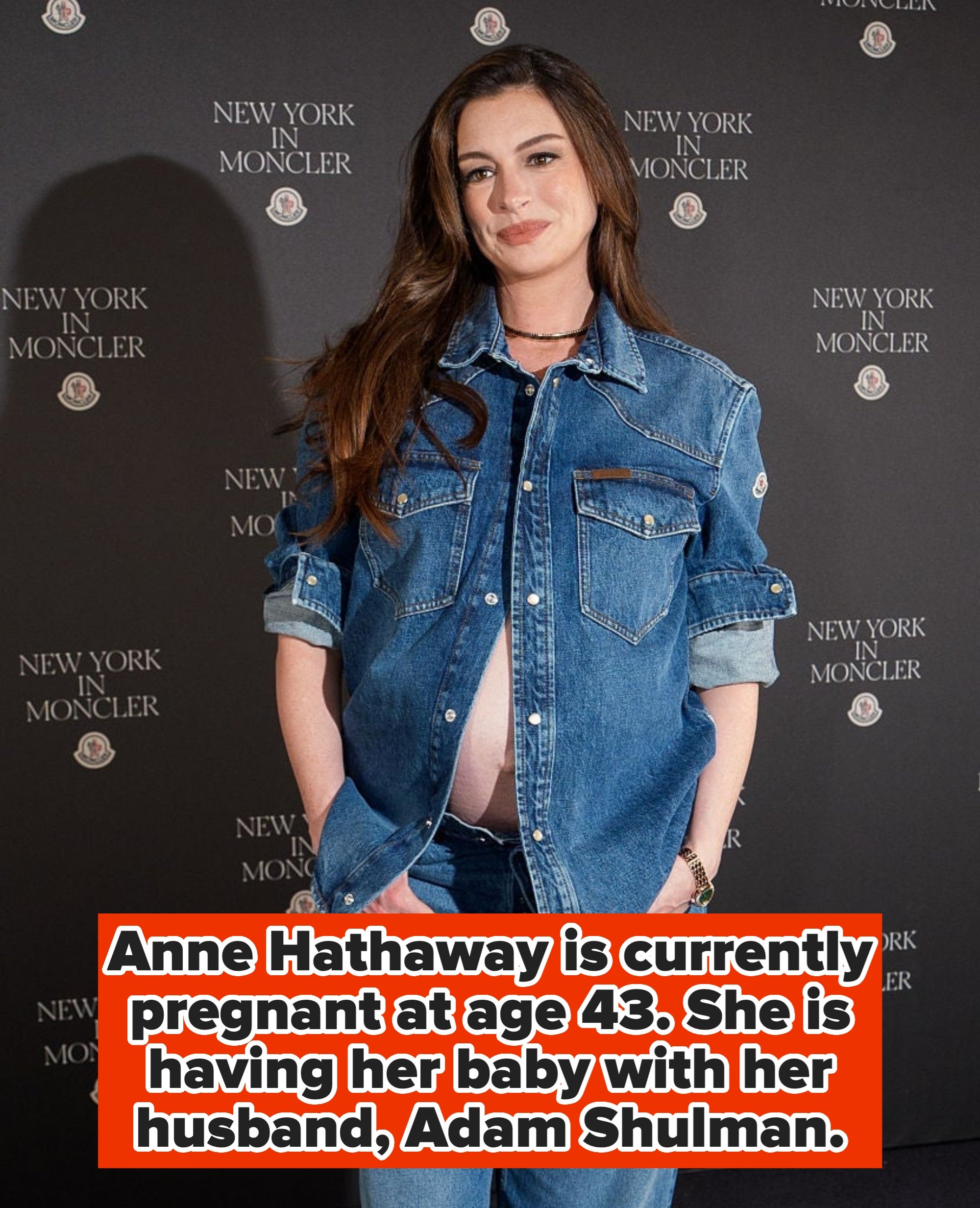 A person poses on the red carpet in a denim jacket and jeans at a "New York in Moncler" event