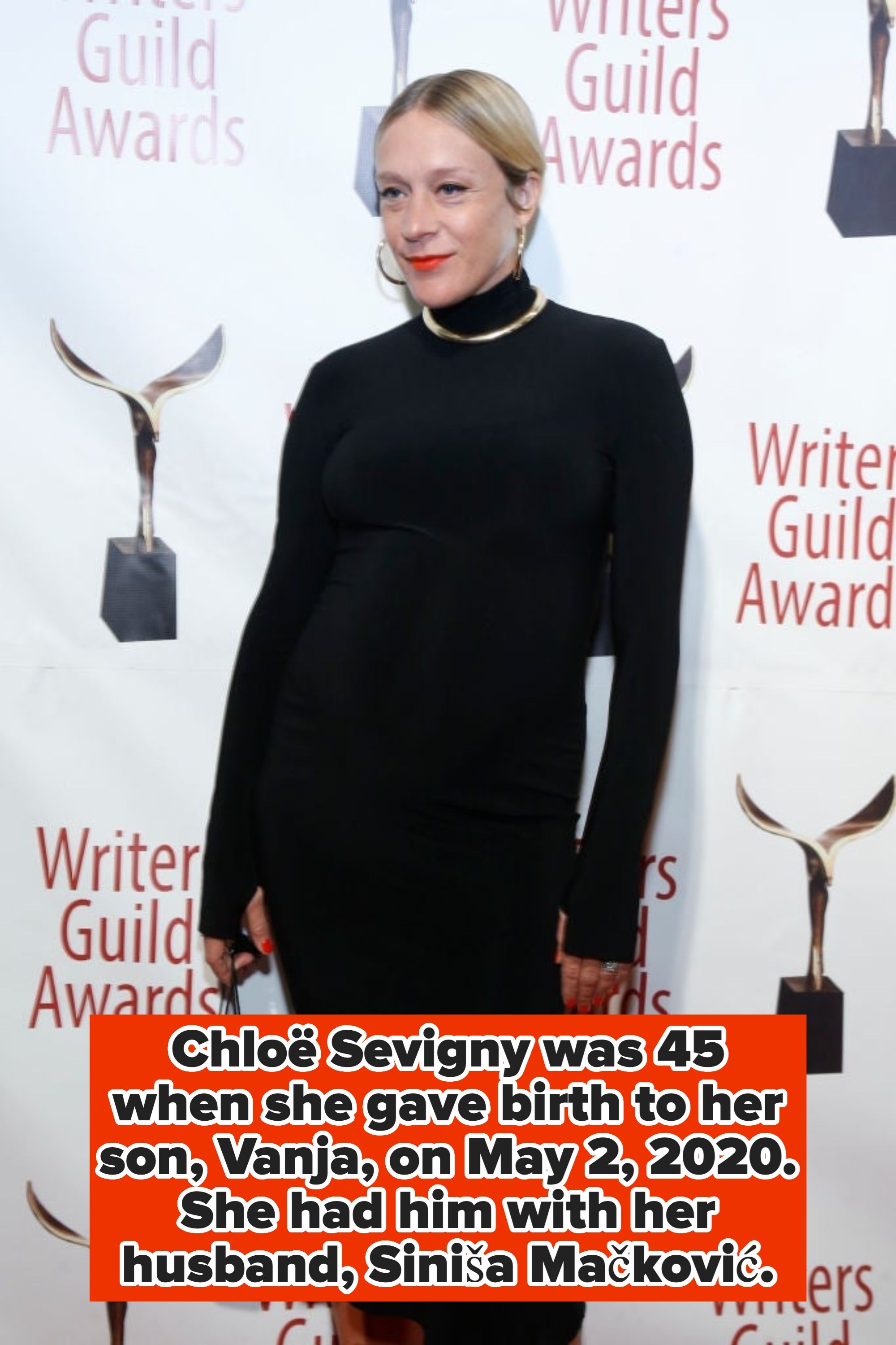 Person in elegant black dress at Writers Guild Awards, posing on the red carpet