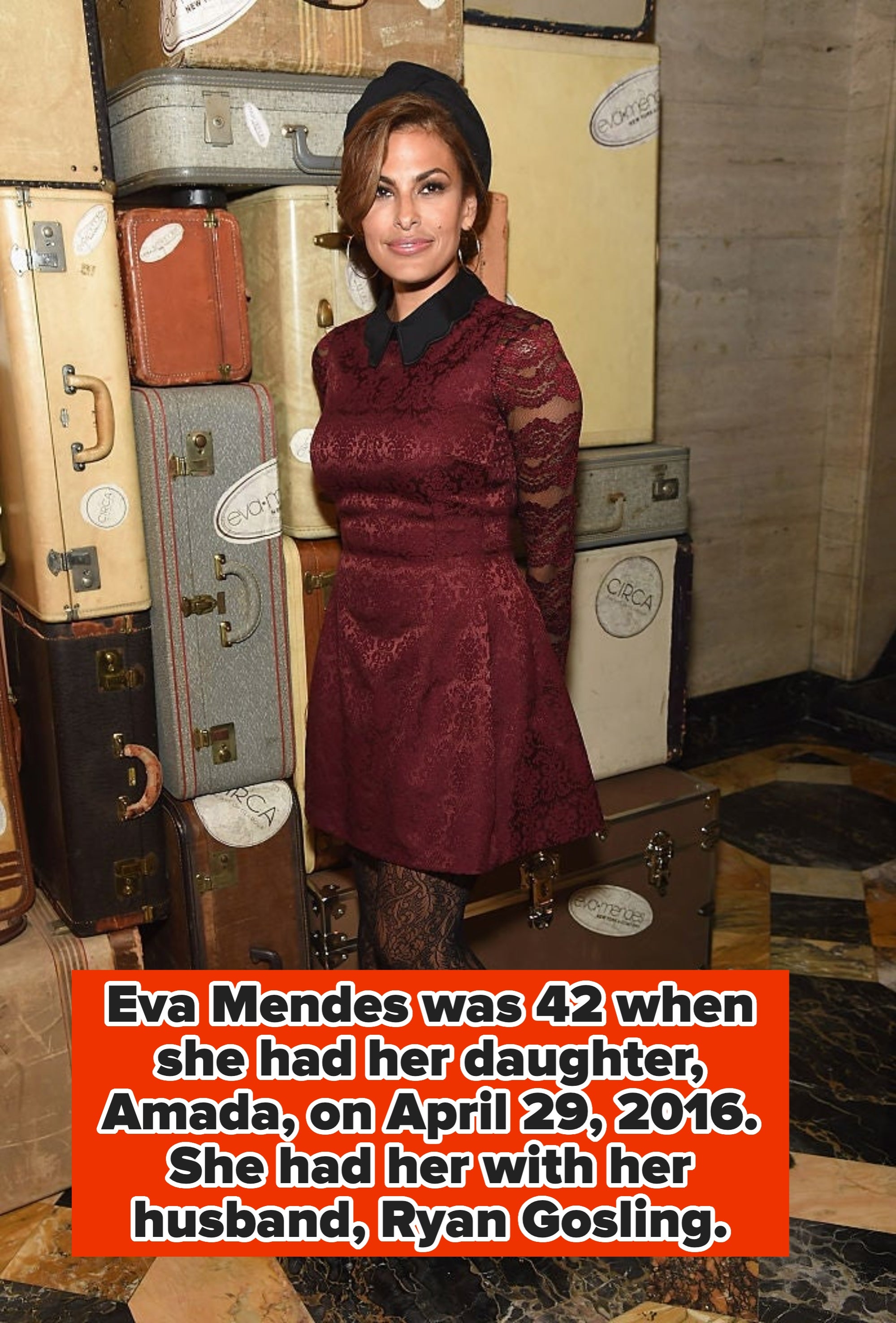 Fashionable woman poses elegantly in a lace dress and hat, surrounded by vintage suitcases