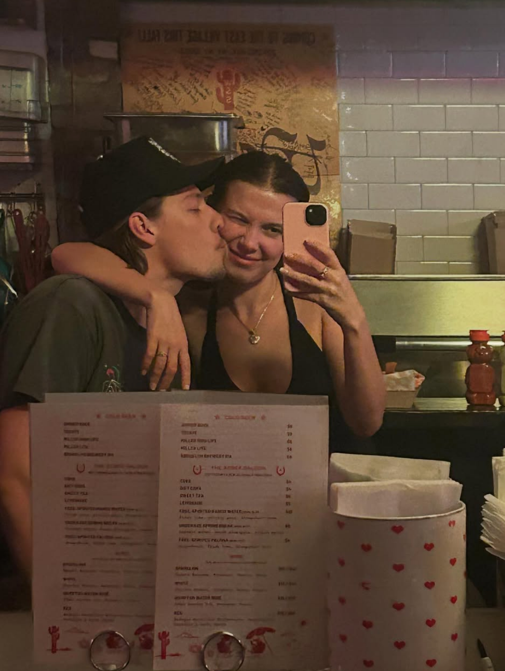 Millie and Jake taking a selfie in a restaurant kitchen