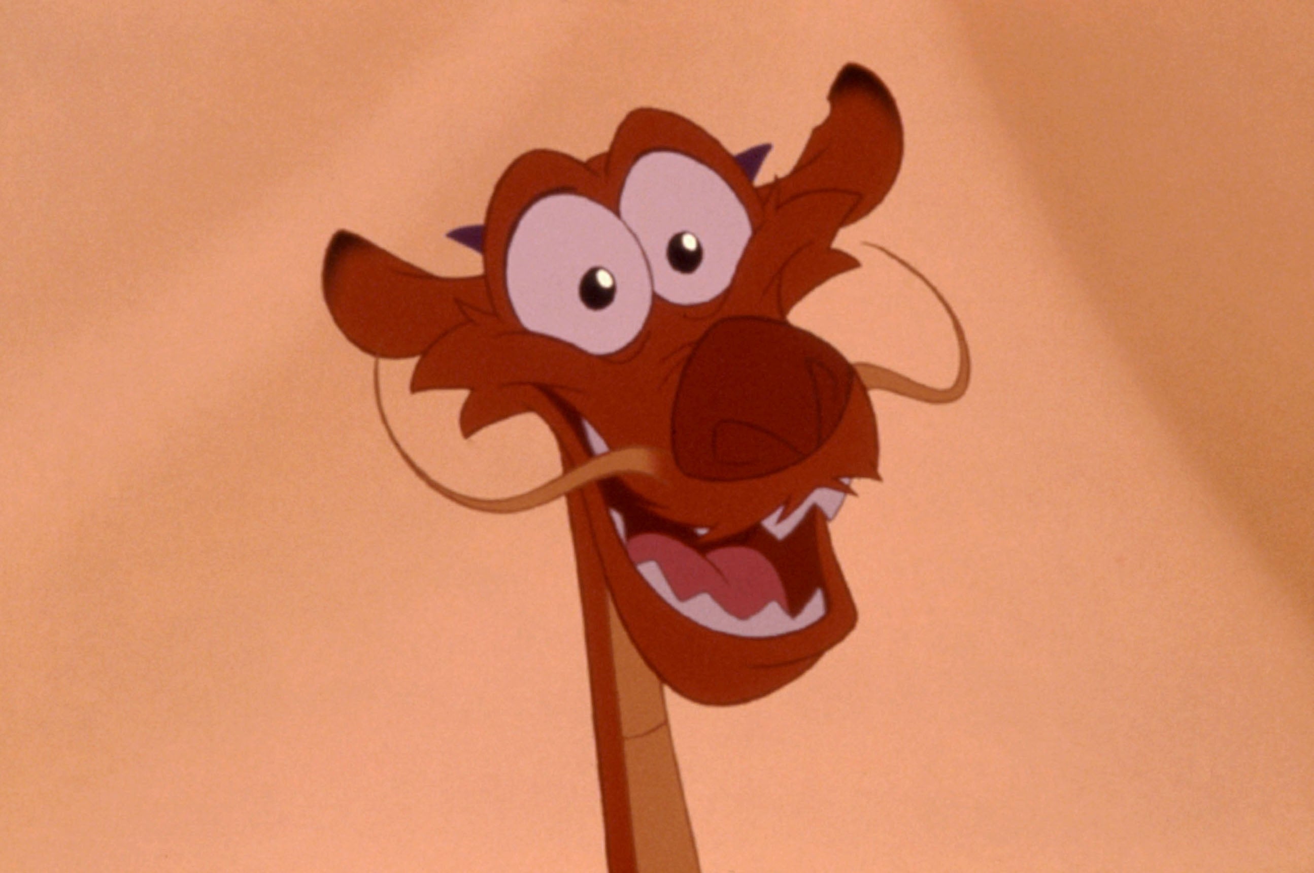 Animated dragon Mushu from the movie "Mulan" appears smiling with wide eyes and agelong whiskers