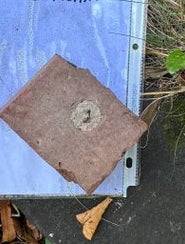 Message on ground reads: "General Ross, thank you for your service. You are needed again. R.I.P." Nearby are a blue lighter and a stone