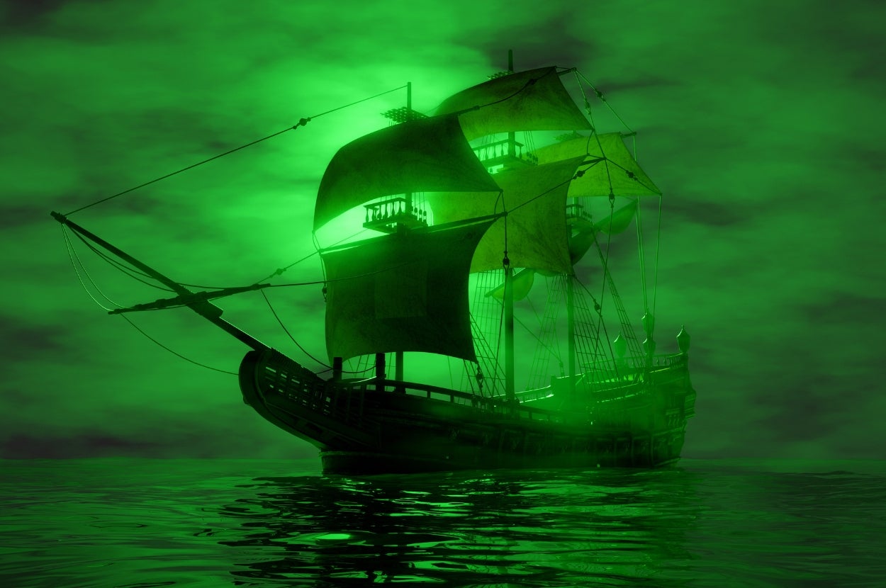 A ghostly sailing ship with tattered sails, glowing eerily against a foggy night sky over the sea
