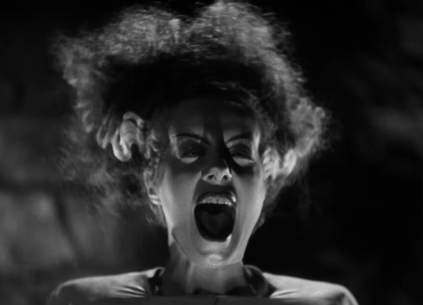 Person in a classic movie scene, screaming with a dramatic expression, hair styled upward, adding to an intense and emotional moment