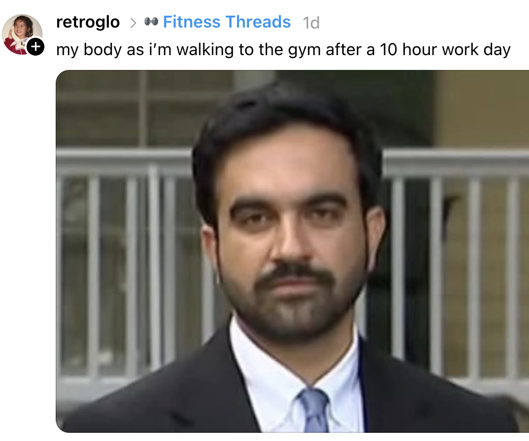 A man with a tired expression stands in a suit. Caption: "my body as i'm walking to the gym after a 10 hour work day."