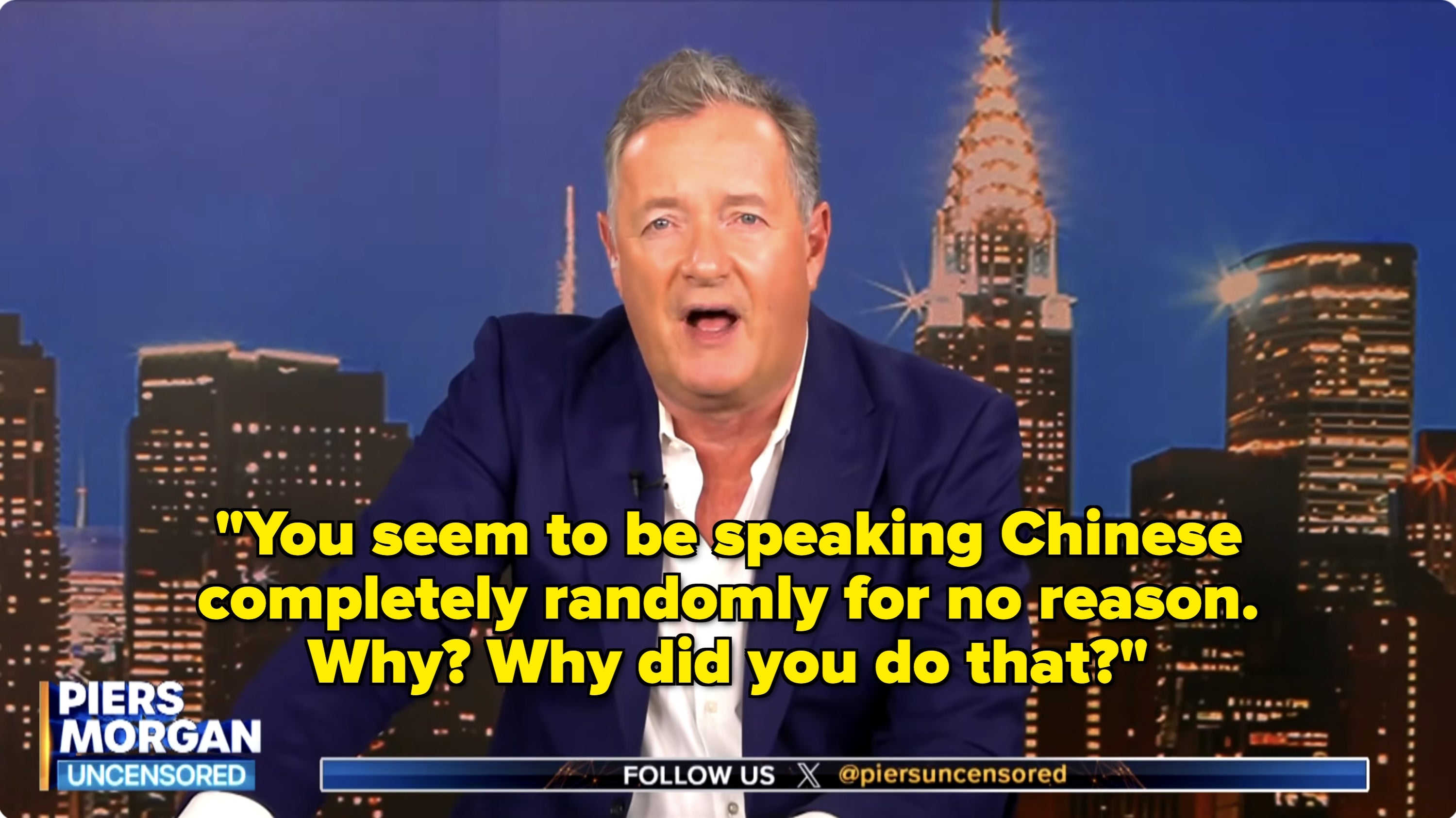 Person in a suit speaking animatedly in front of a cityscape backdrop, labeled "Piers Morgan Uncensored."