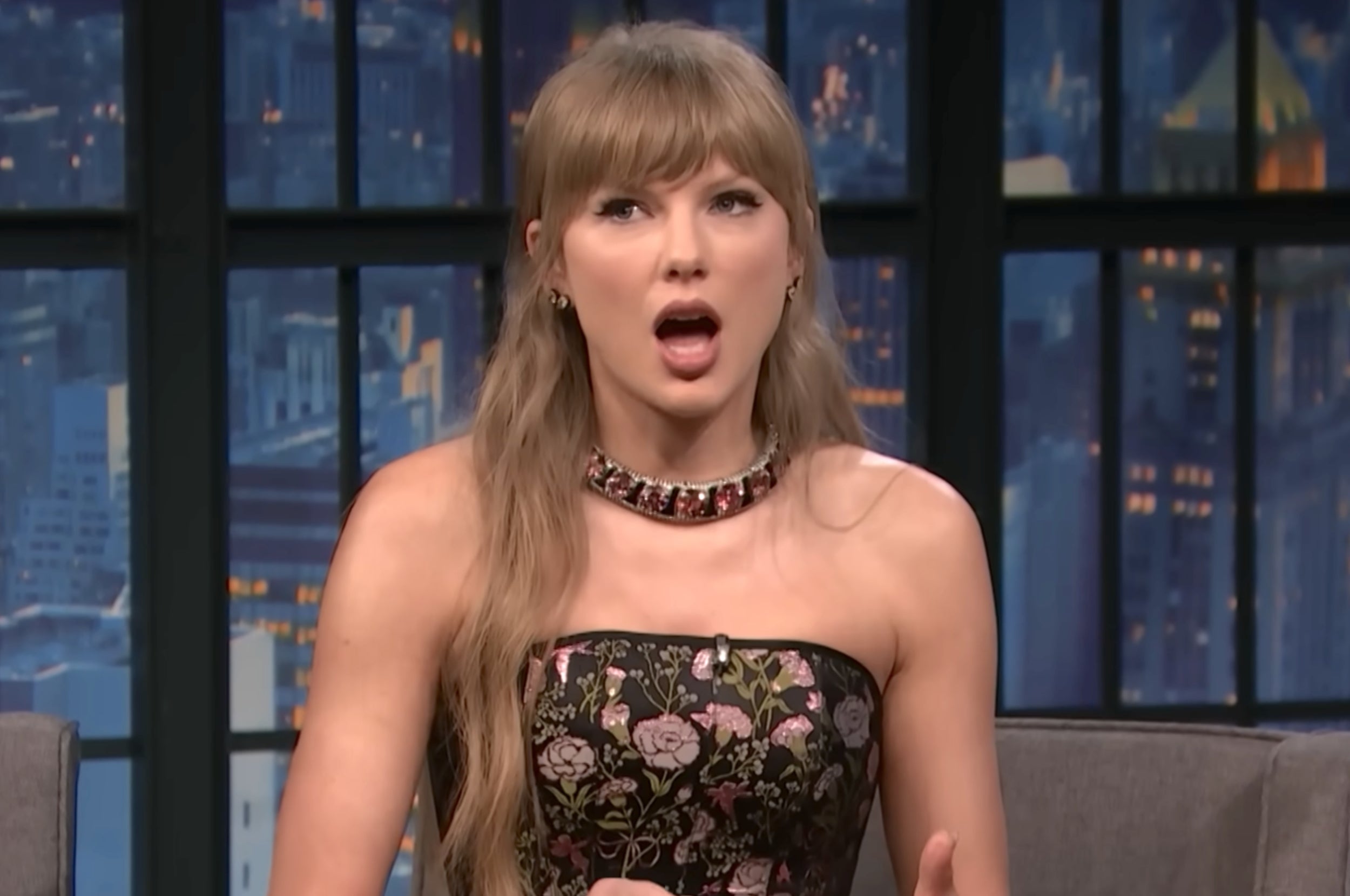 Taylor Swift looking up and opening her mouth on Late Night With Seth Meyers