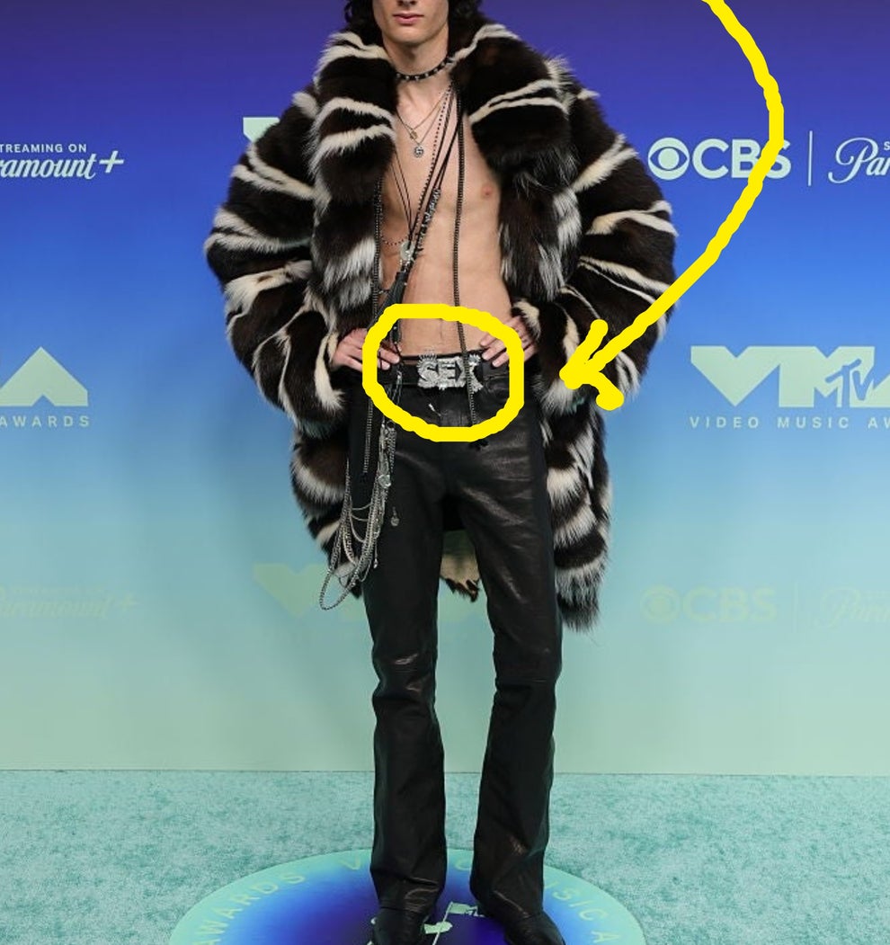 Person in striped fur coat, leather pants, and accessories on VMA red carpet