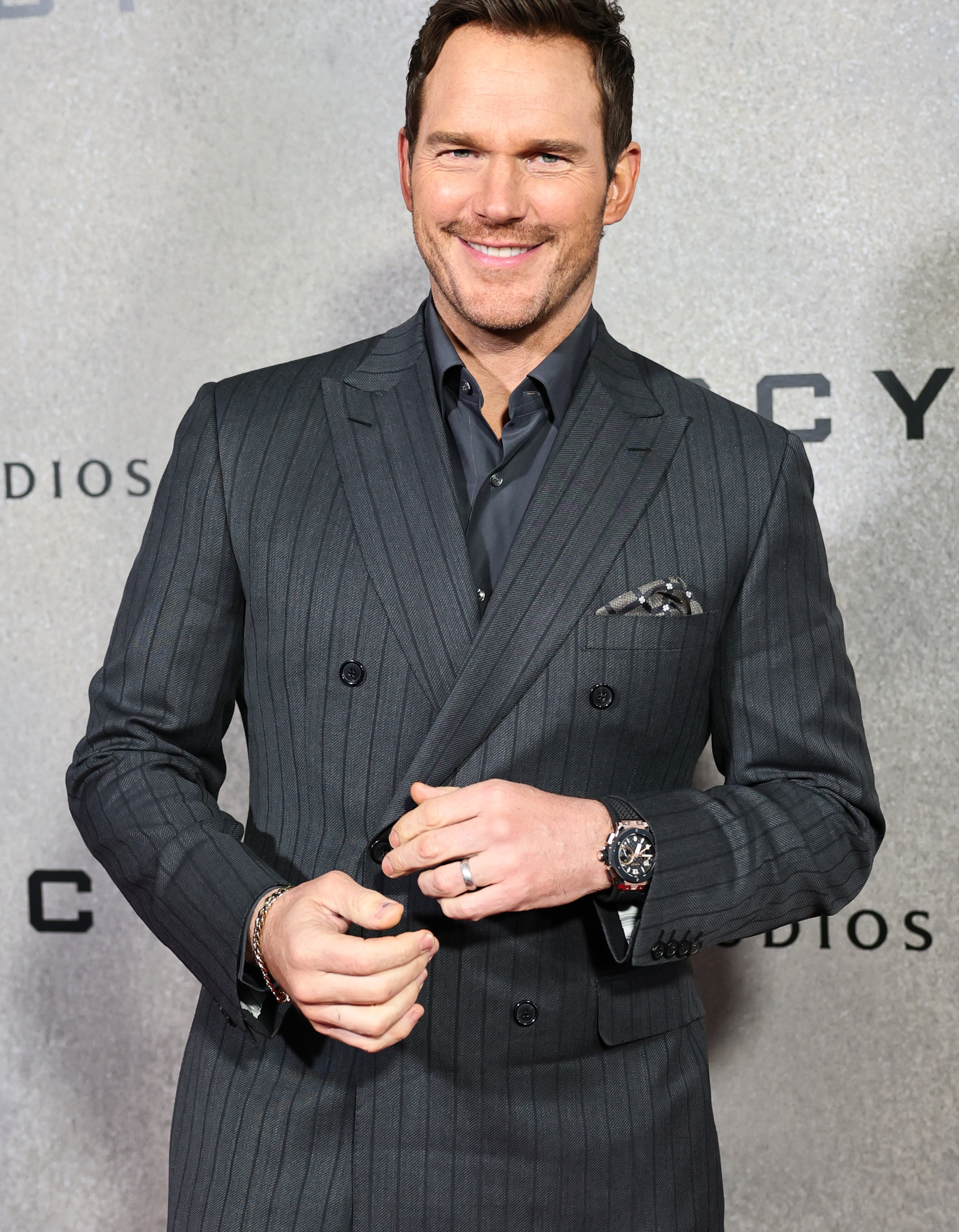 Chris Pratt standing on a red carpet at an event