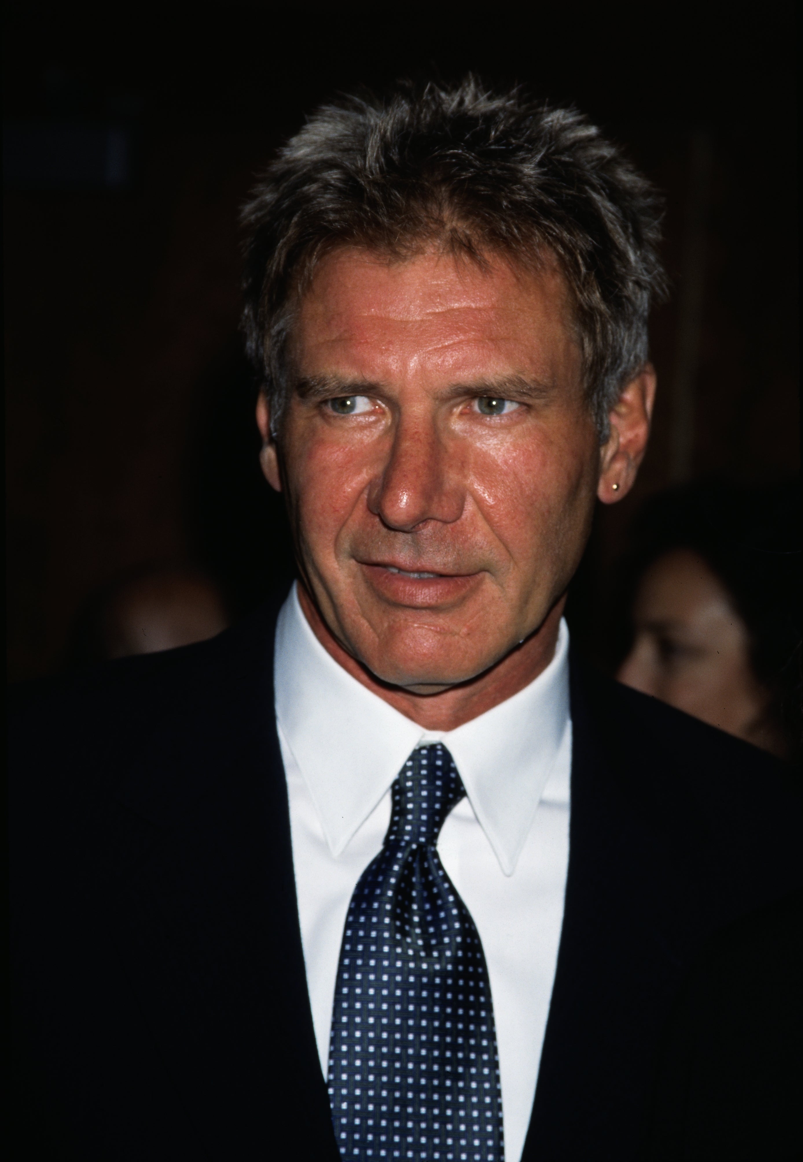 Actor in a classic suit and polka dot tie at a formal event