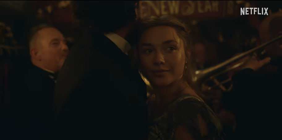 A person in elegant attire dances at a formal event, with musicians playing in the background and "Netflix" logo visible