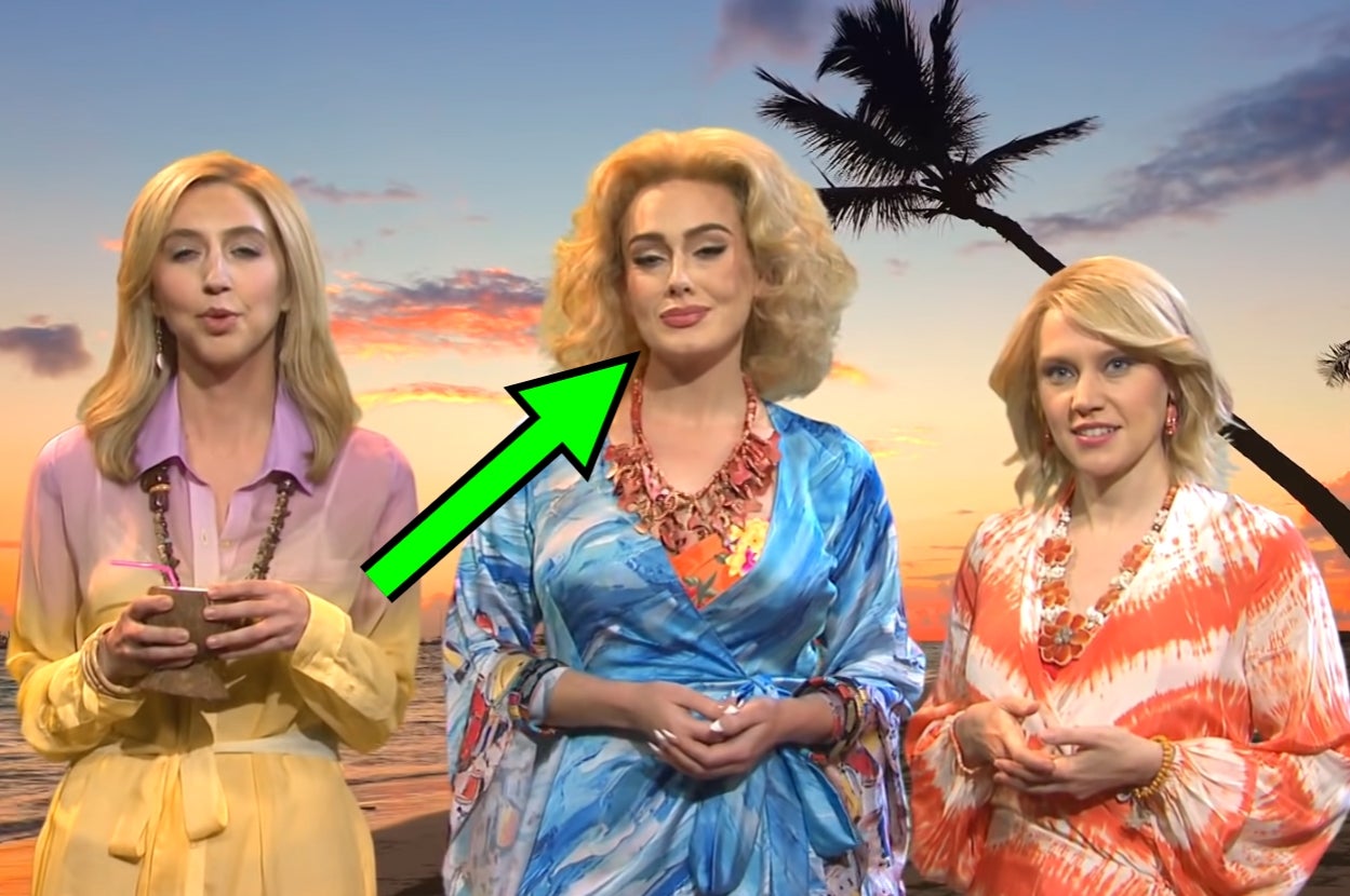 Three people in stylish tropical attire stand in front of a beach backdrop with palm trees. One person is highlighted with an arrow