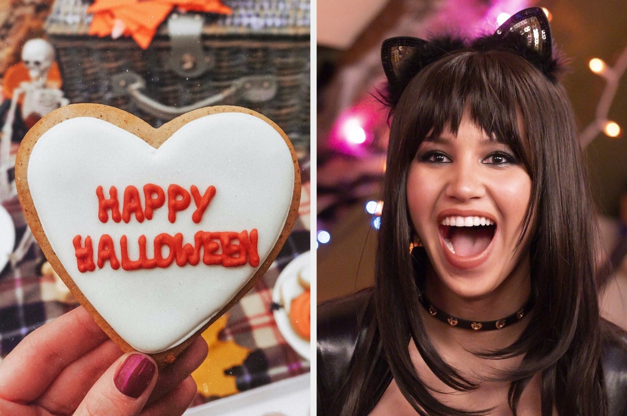 Heart-shaped cookie with "Happy Halloween" icing; person in a cat-themed Halloween costume smiling widely