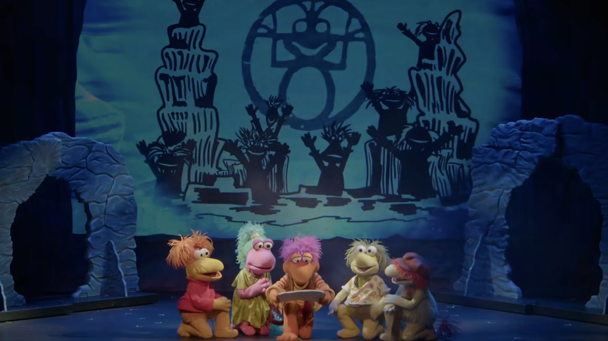 Puppet characters are gathered astir a ample publication connected a signifier with a whimsical backdrop