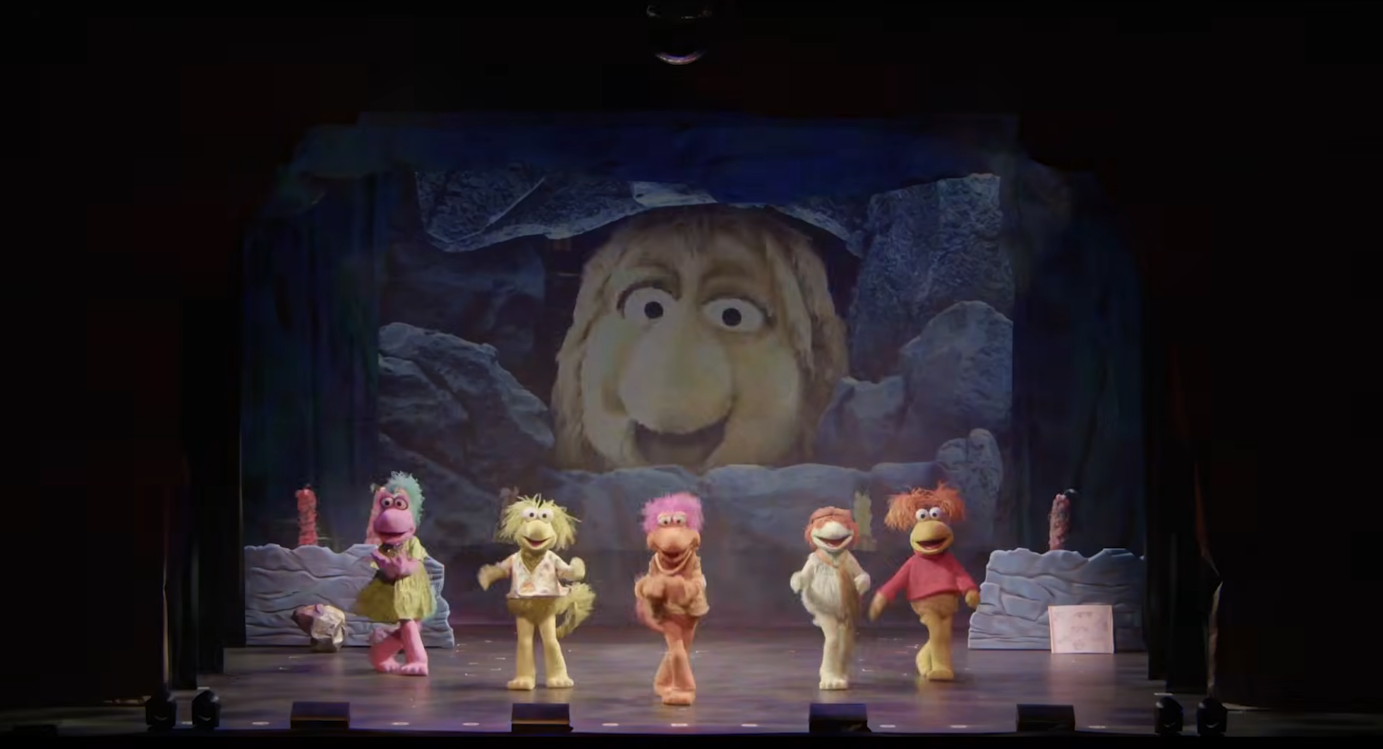 Puppet characters execute connected signifier with a ample puppet look backdrop, reminiscent of classical puppet TV shows