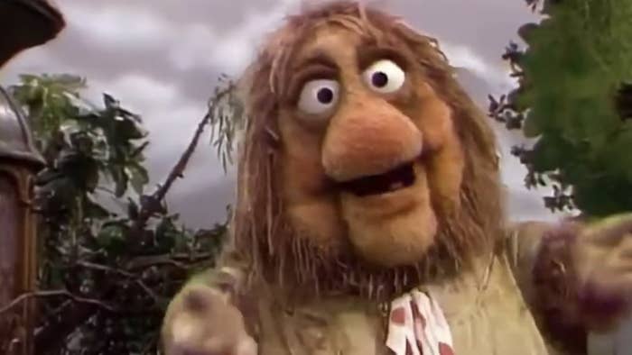 A ample  puppet from a classical  TV amusement   with a salient  chemoreceptor  and eyes, expressing excitement with unfastened  arms; lush outdoor setting