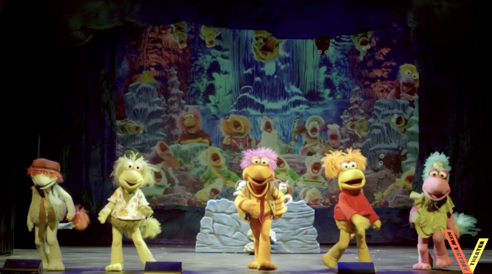 Puppets from the amusement "Fraggle Rock" execute connected signifier with a colorful backdrop of characters and nature