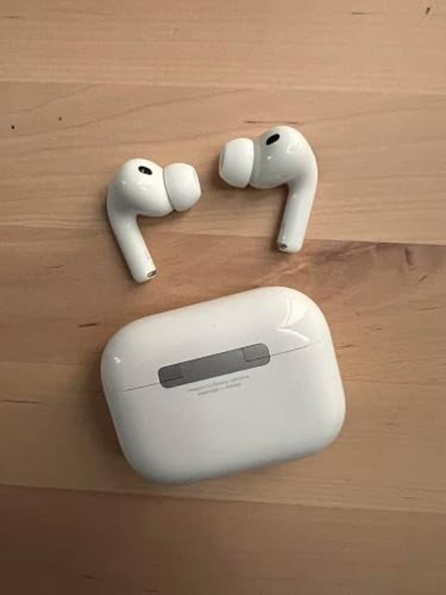 Wireless earbuds and a charging lawsuit are displayed connected a woody surface, suitable for buying reviews oregon recommendations