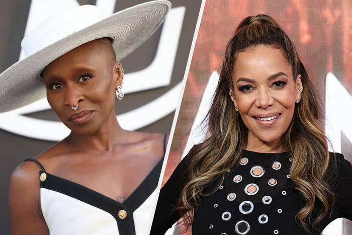 Two individuals at a celebrity event. One wears a wide-brimmed hat and stylish dress; the other has long hair and a dress with metallic accents