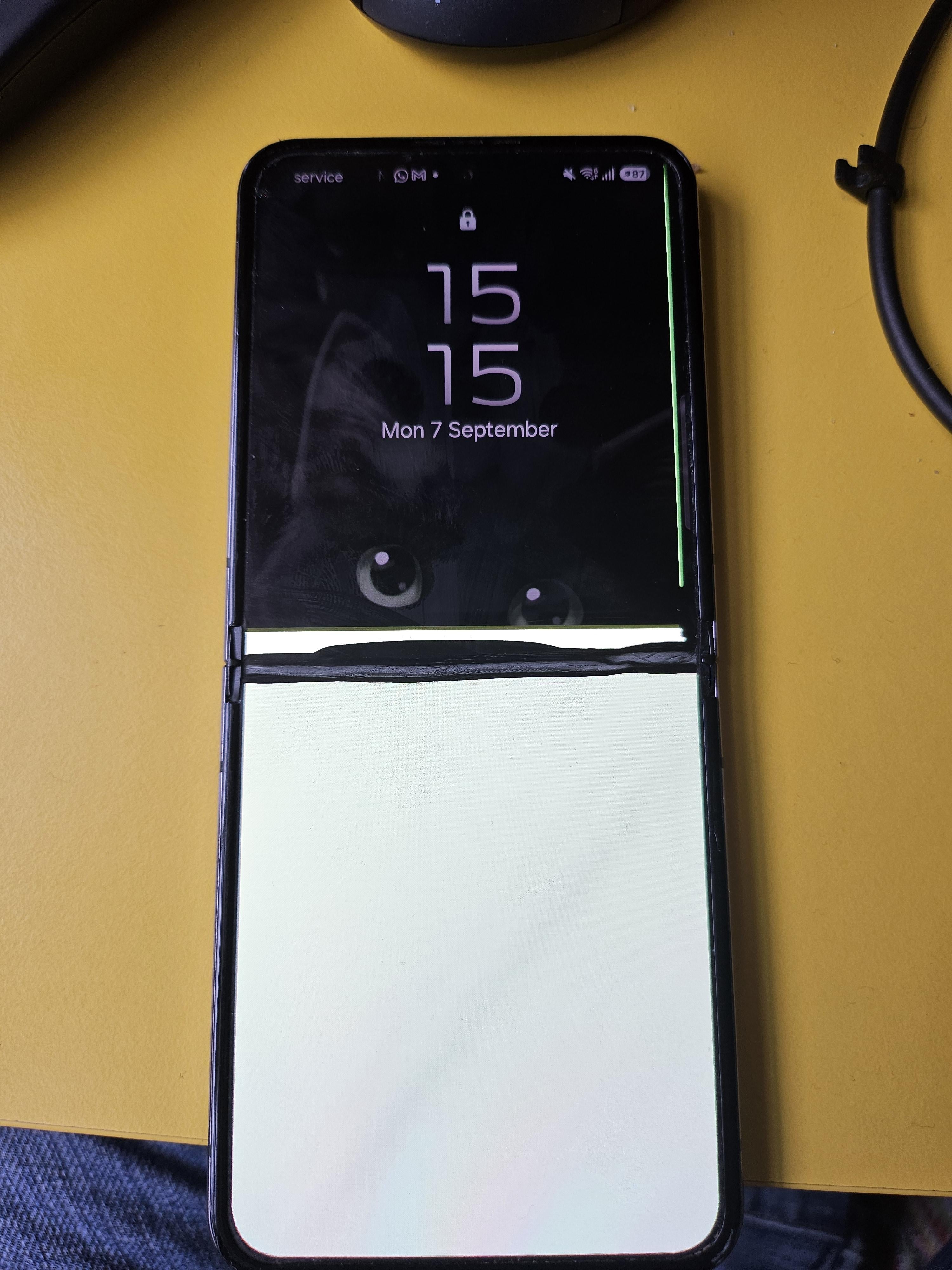 Foldable smartphone with screen displaying time and date, partially folded showing another area for interaction