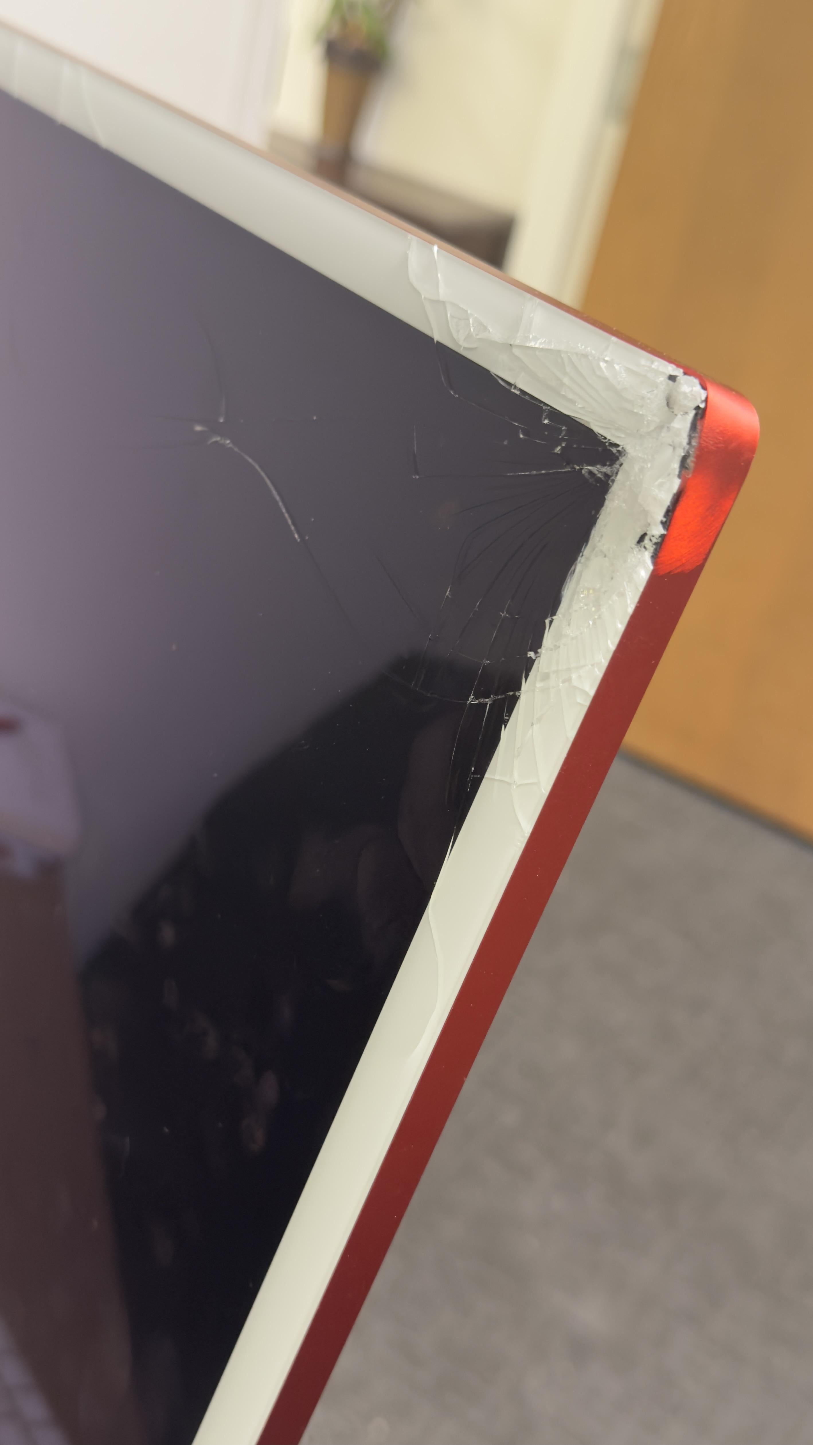 Close-up of a computer screen with a cracked corner on the frame, showing slight damage