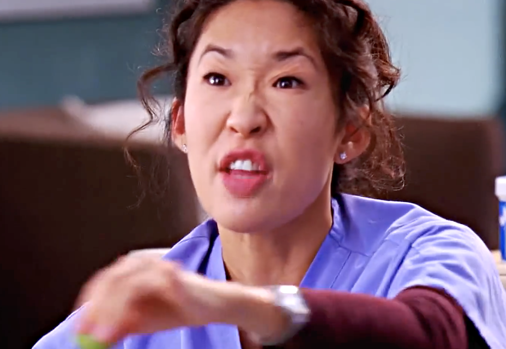 Person successful  a bluish  scrub apical  making an expressive gesture, perchance  conveying vexation  oregon  urgency. Indoors, with blurred background