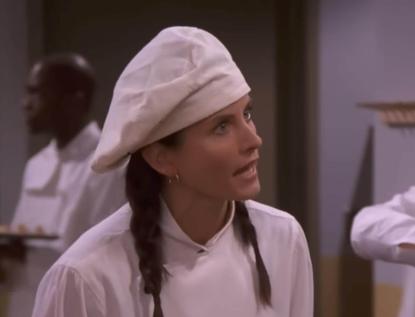 Person successful  a chef's outfit with pigtails, speaking animatedly successful  a room  setting