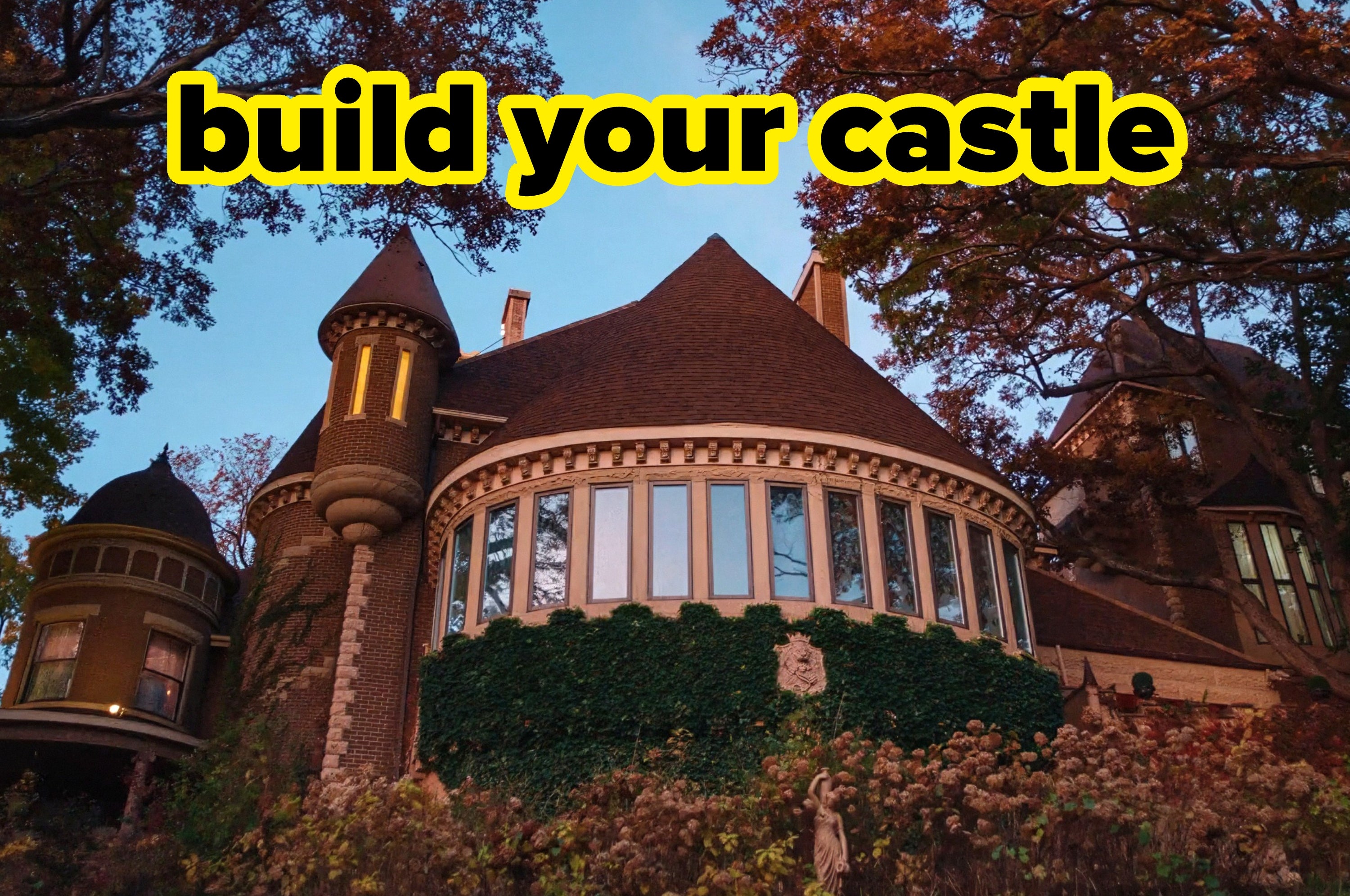 Majestic brick castle with round towers and large windows surrounded by lush foliage; bold text reads, "build your castle."