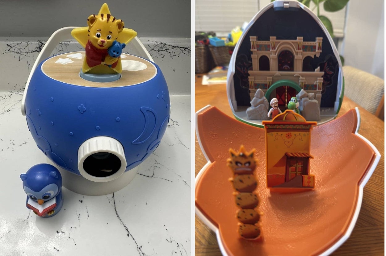 Two children's projector toys: one with a cartoon character and toy penguin, the other shaped like an orange seashell with characters inside