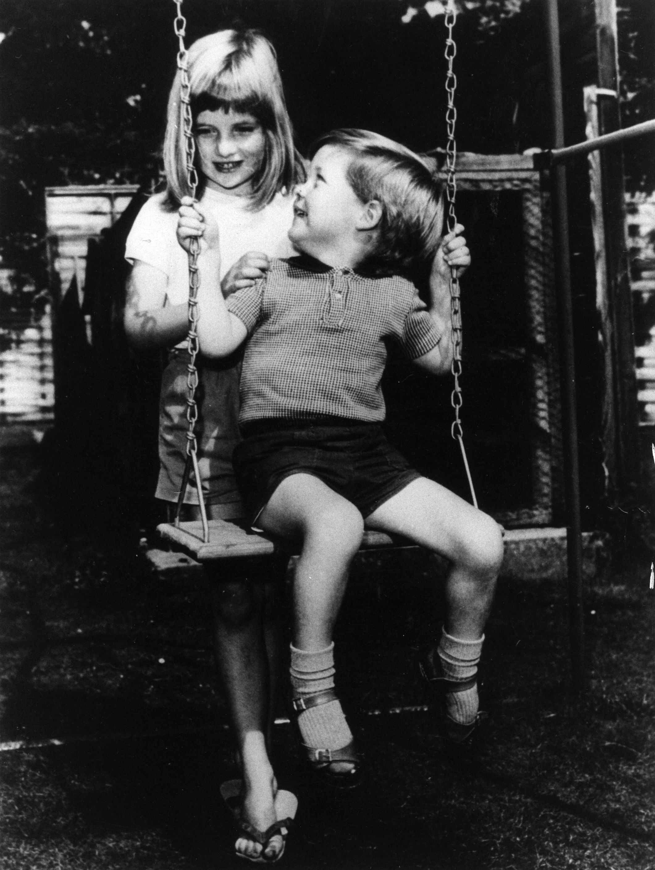 Lady Diana Spencer pushing her brother Charles on a swing