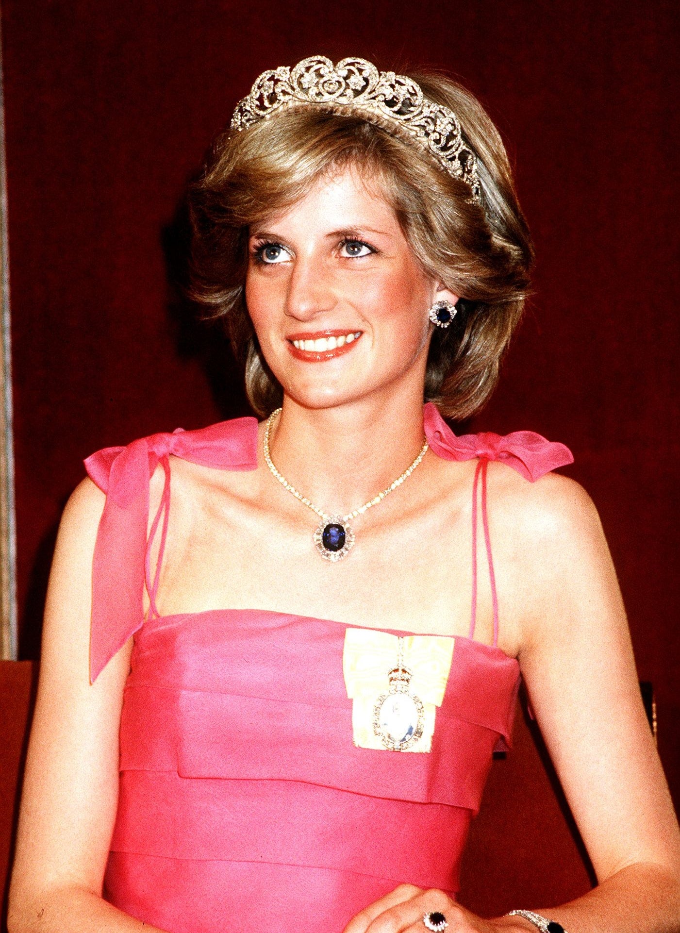 Princess Diana wearing a pink dress and a tiara