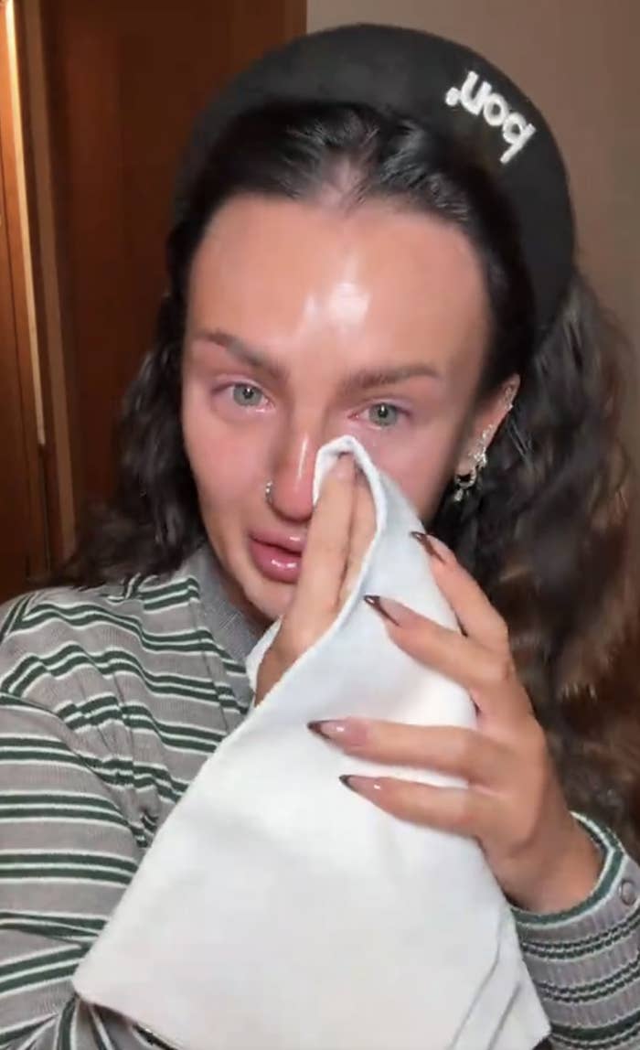 Mikayla wiping tears with a towel successful  a TikTok video