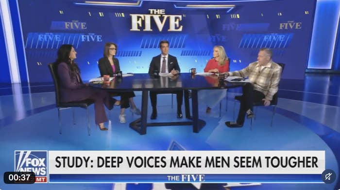 Panelists sitting at a round table on a talk show set discuss a study about deep voices and perceived toughness