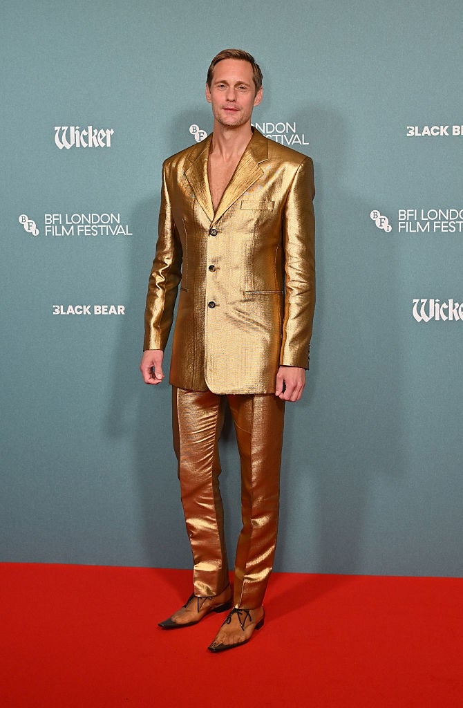 Person in metallic suit on red carpet at BFI London Film Festival, posing confidently