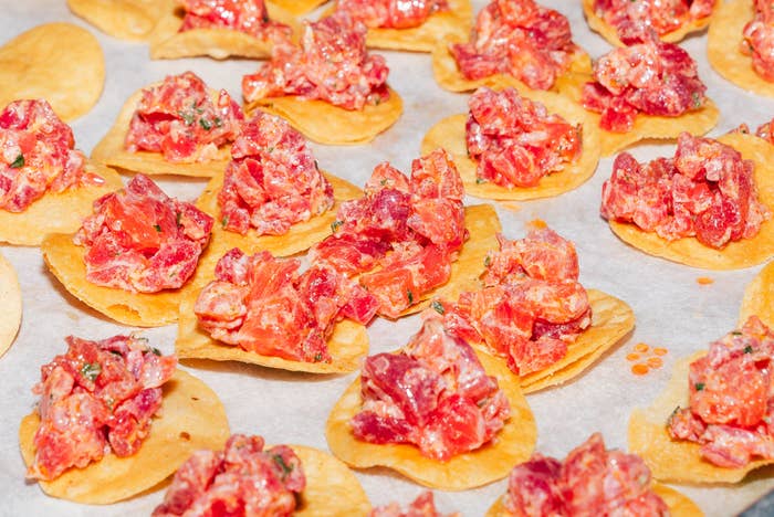 Chips topped with seasoned earthy   tuna placed connected  parchment paper, acceptable   to service  arsenic  an appetizer