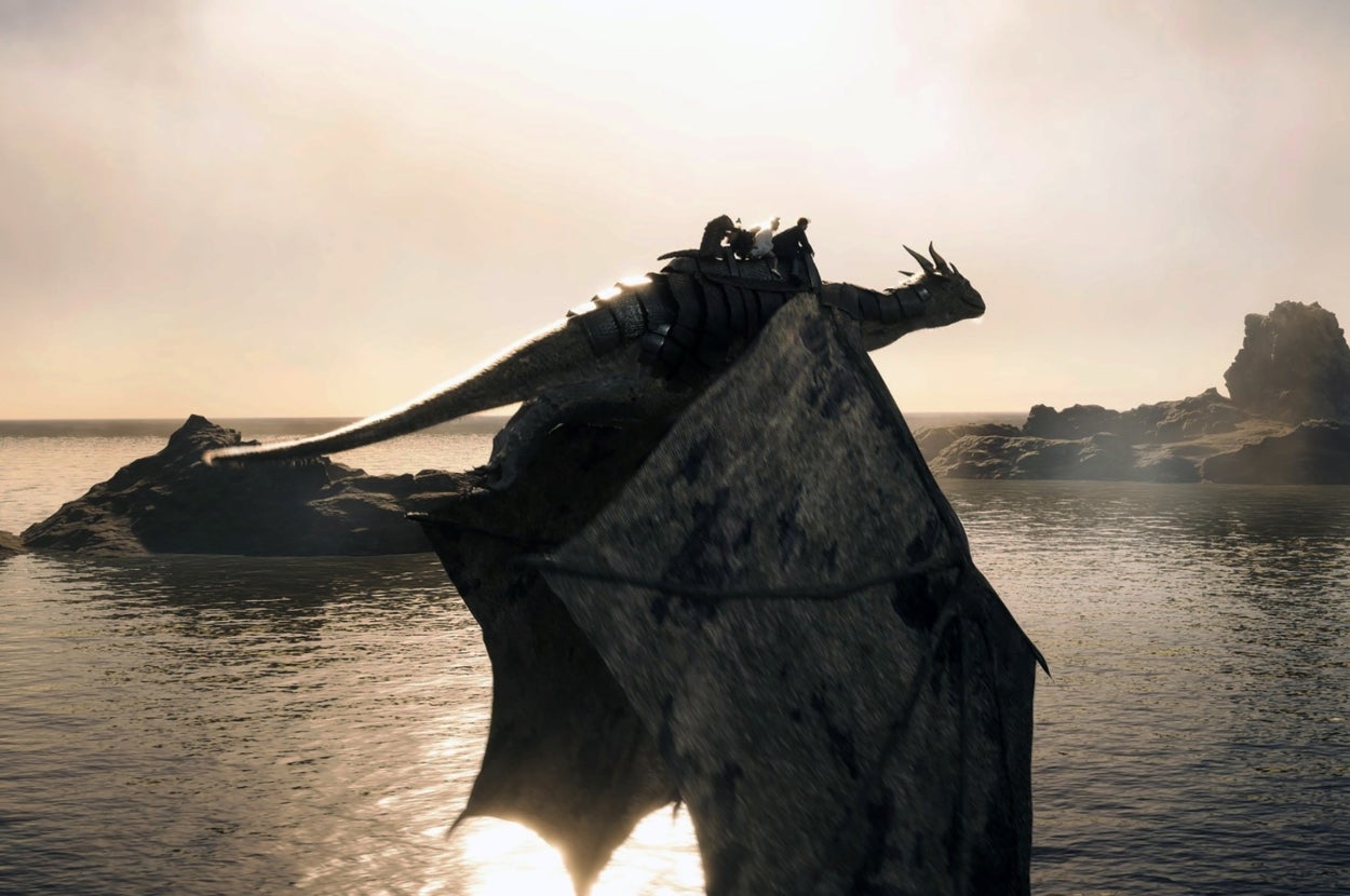 Scene from "THE SECRET KINGDOM" where a person in rugged attire rides a dragon flying over a calm body of water, with a rocky formation in the distance