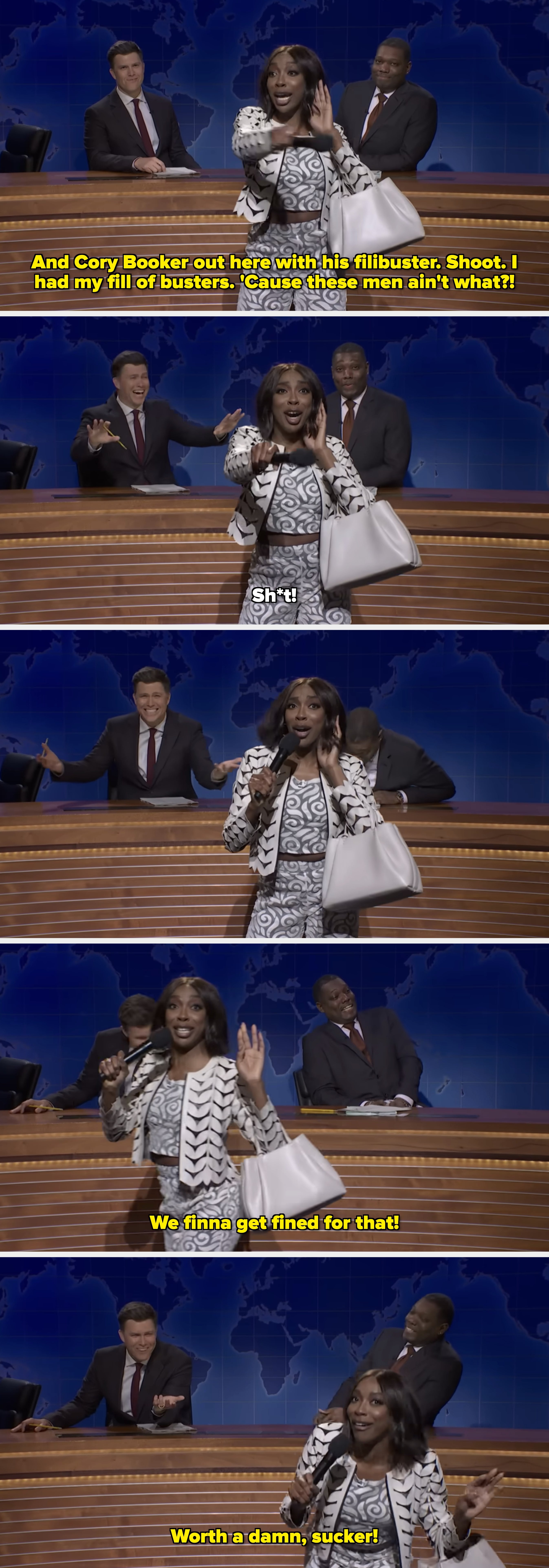 A performer energetically gestures on a comedy news set with two seated anchors behind. They wear a patterned suit and hold a white bag
