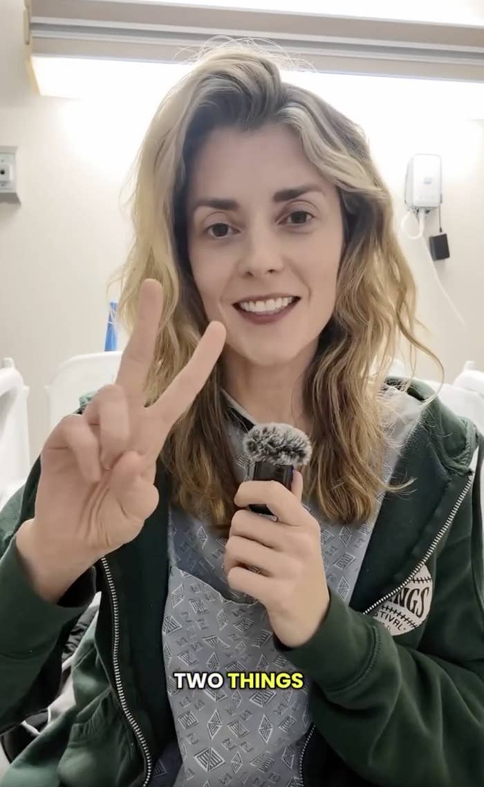 Person smiling and holding a microphone, wearing casual clothing. Hand gesture displaying two fingers. Text at the bottom says, "TWO THINGS."