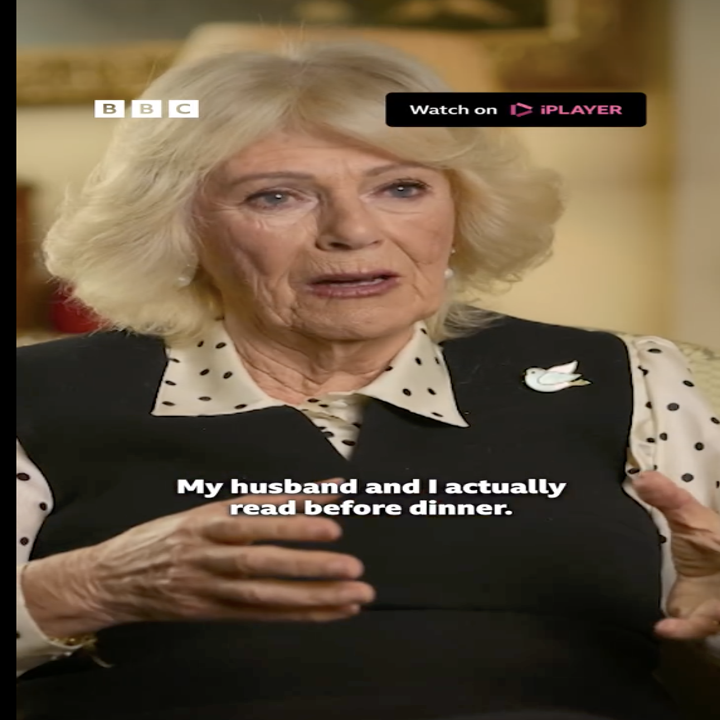 Woman with white hair, wearing polka dot blouse and dark vest, speaking in a BBC interview. Caption reads: "My husband and I actually read before dinner."
