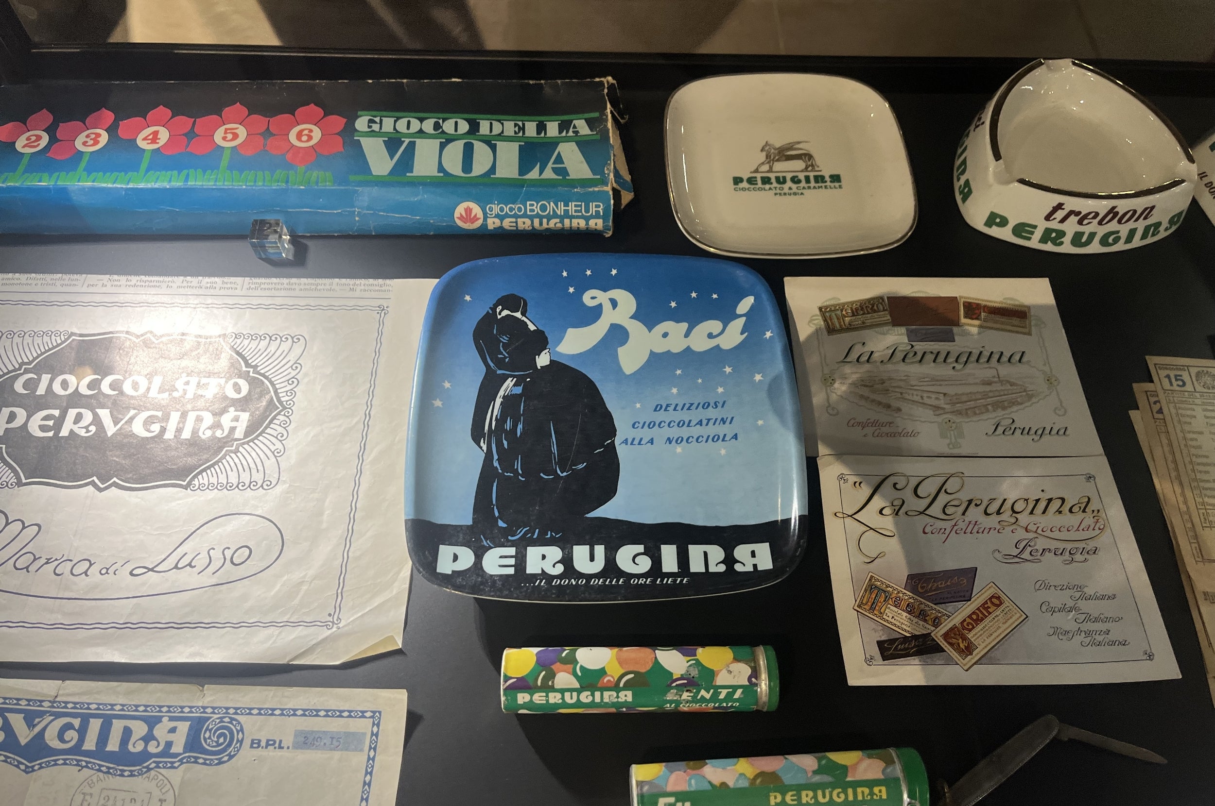 Collection of vintage Perugina chocolate ads and packaging, including a "Baci" plate and wrappers
